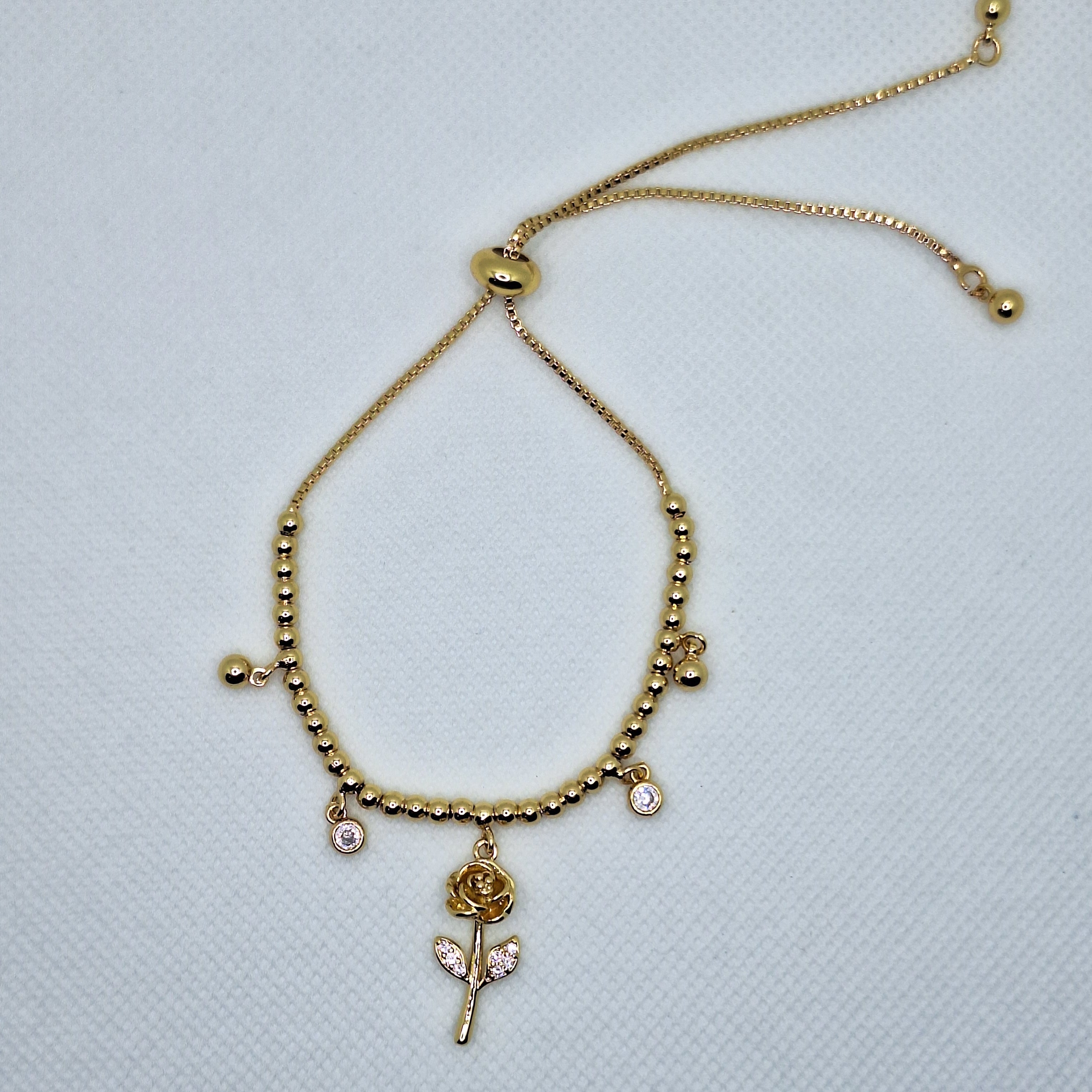 Pulsera de Balines con Dije Flor | Oro chino Dorada