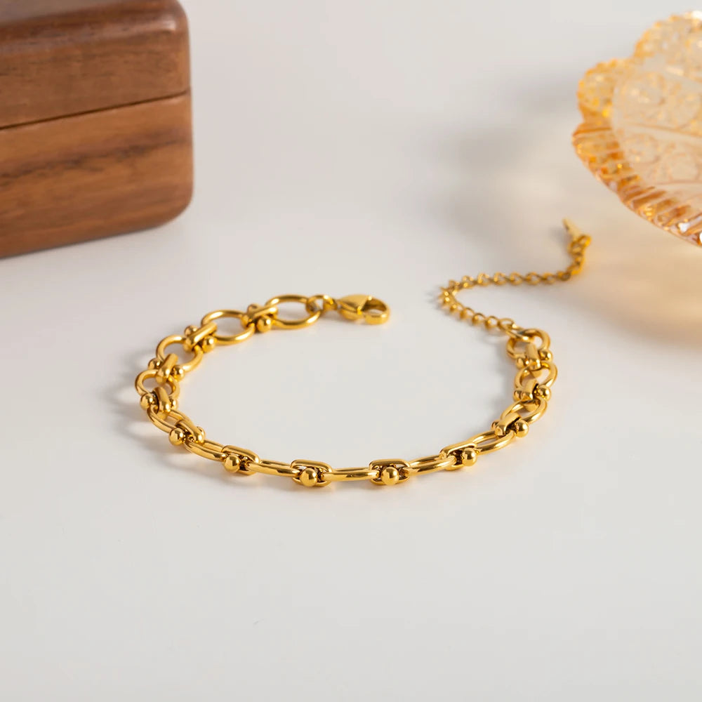 Pulsera De Eslabones Ovalados Con Detalles De Nudos Centrales | Dorado